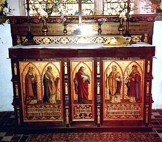 19th century altar with painted panels of Christ, with St Nicholas and St Swithin on the right and St Birinius and St Boniface on the left