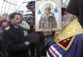 Archbishop giving icon to ship captain
