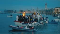 Statue and official party on boat