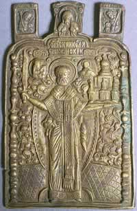 In Russia St. Nicholas the Wonderworker is often shown as Holy Hierarch Nicholas of Mozhaisk. These icons show a full-length Nicholas with a sword in his right hand and a city in his left because the prayers of St. Nicholas saved the city of Mozhaisk from enemy attack. 18th Century Russian icon with the angels Gabriel and Michael at the top with the Vernicle (Holy Face). &mdash;St. Nicholas Center Collection